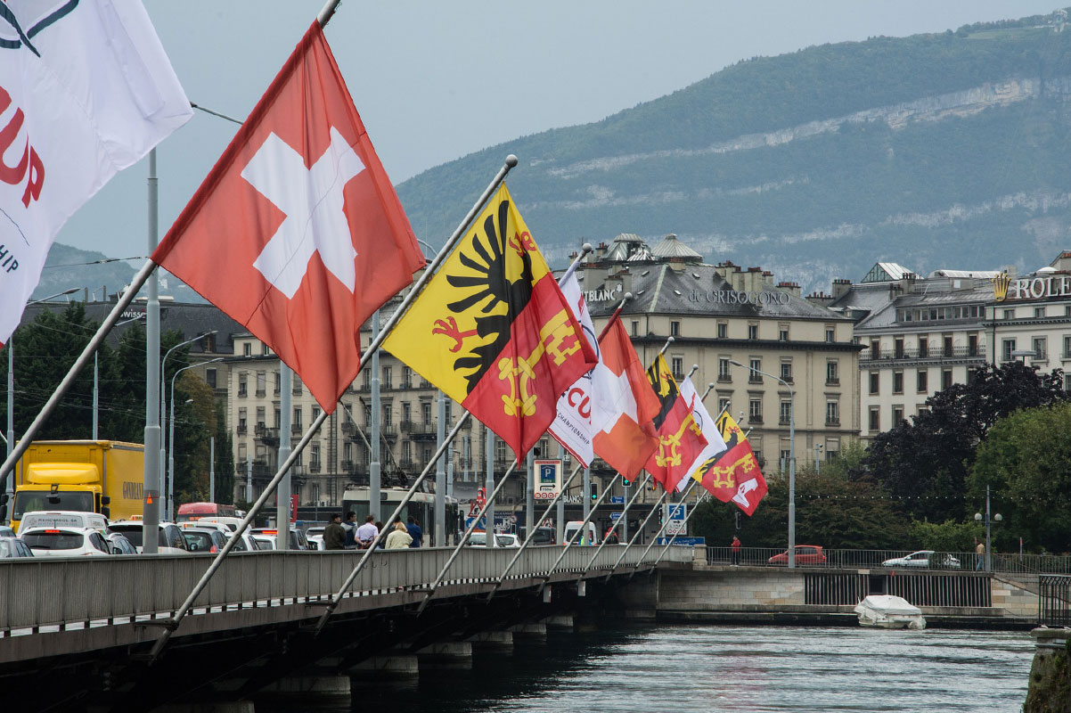 Geneva Bridge with Flags over River